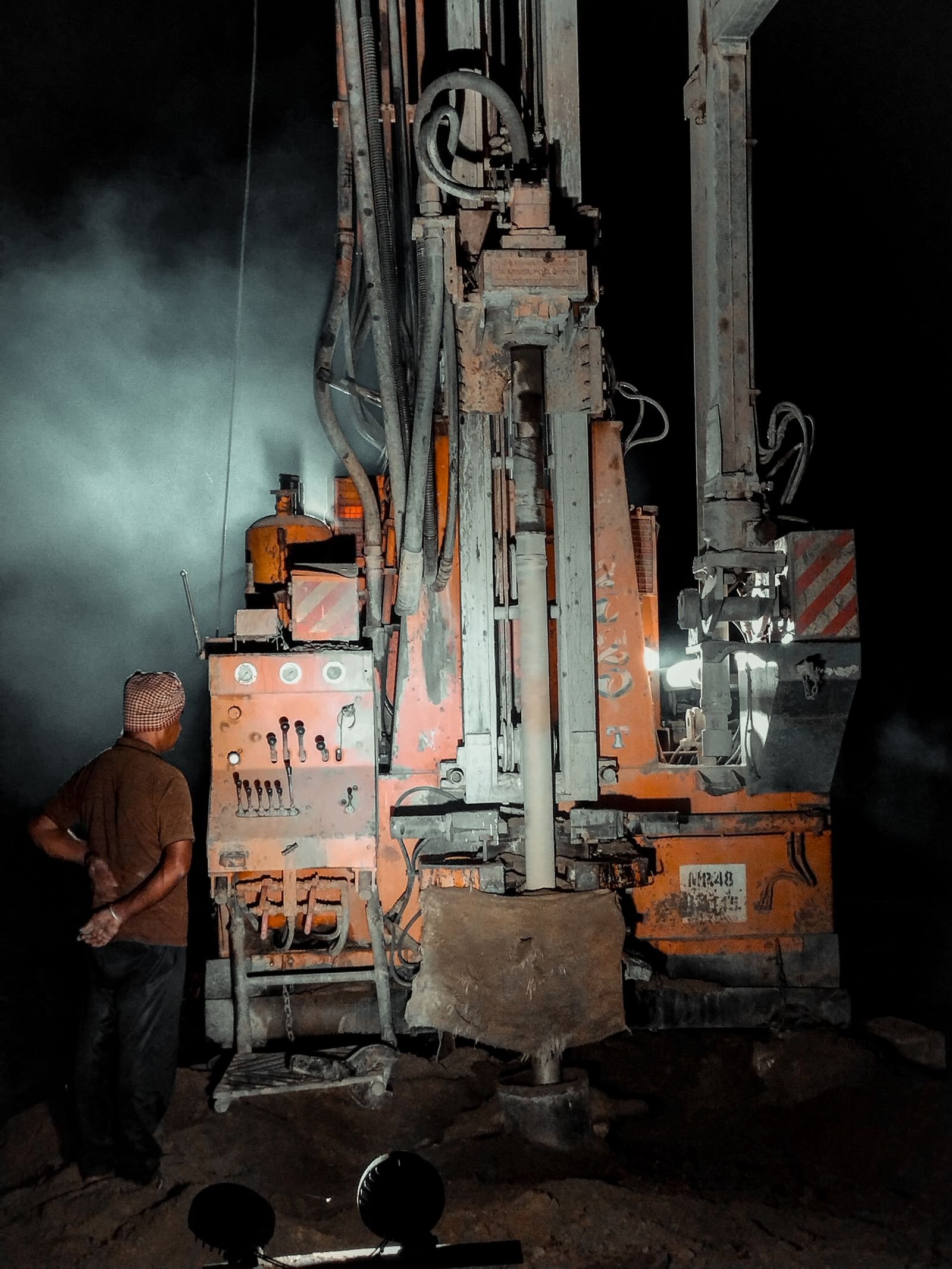 Water-well drilling rig and operator at work