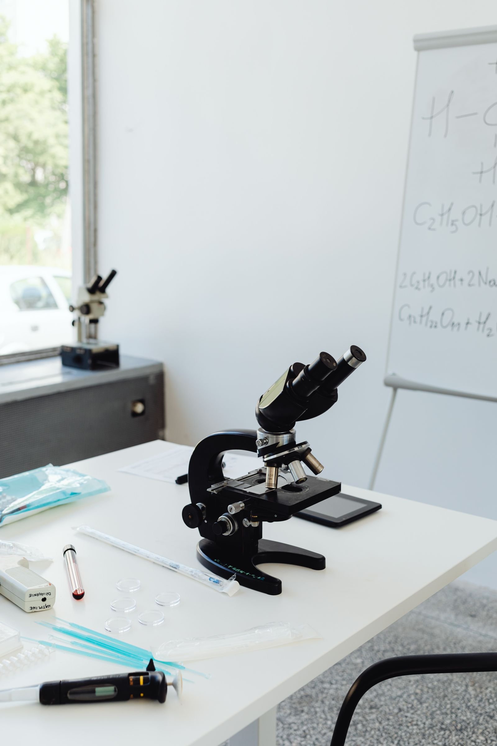 Microscope and science equipment on a laboratory workbench