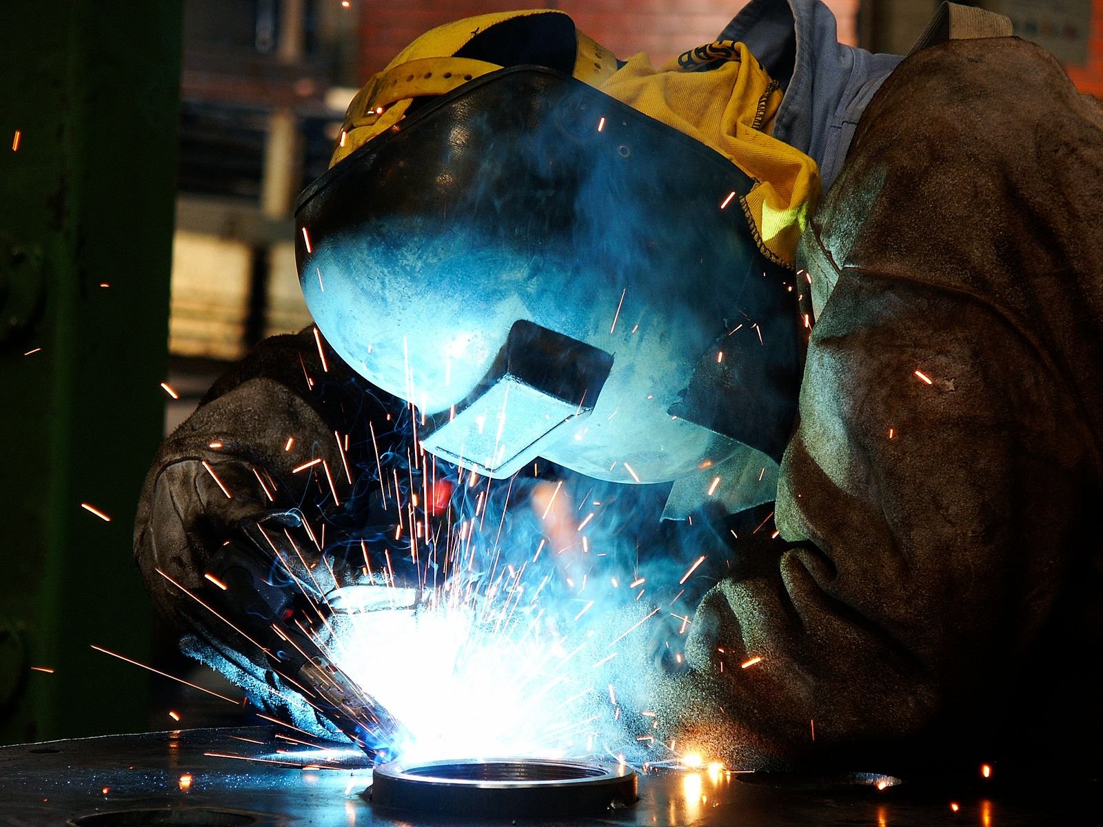 Metalworker welding steel in a workshop